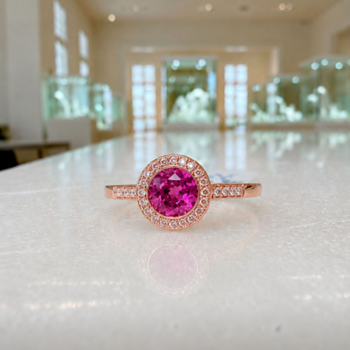 PINK CORUNDUM & DIAMOND HALO RING